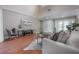 Comfortable living room showcases wood floors, neutral walls, and access to the foyer through elegant double doors at 13906 Captains Reef Ct, Tampa, FL 33624