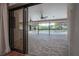 Covered outdoor patio overlooks a screened-in pool and lush landscaping, perfect for relaxation and entertainment at 13906 Captains Reef Ct, Tampa, FL 33624