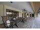 Outdoor dining area under a covered patio with ceiling fans, bar, and brick pavers at 13906 Captains Reef Ct, Tampa, FL 33624