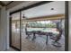 Outdoor dining area with a serene view of the pool and the lush surroundings at 13906 Captains Reef Ct, Tampa, FL 33624