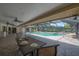 A screened-in pool with a table, chairs, and view of the backyard at 13906 Captains Reef Ct, Tampa, FL 33624
