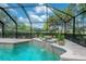 Close-up of the pool's edge with water feature and view of landscaping at 13906 Captains Reef Ct, Tampa, FL 33624