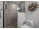 Contemporary shower with glass door and wall is nicely tiled with pebbles on shower floor at 13906 Captains Reef Ct, Tampa, FL 33624