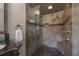 Modern tiled shower with glass enclosure, rainfall showerhead, and comfortable seating at 13906 Captains Reef Ct, Tampa, FL 33624