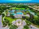 Breathtaking aerial view of community pool, tennis courts, and lush landscaping at 14537 Mirabelle Vista Cir, Tampa, FL 33626