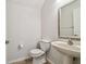 Powder room features a pedestal sink, toilet, and decorative mirror at 14537 Mirabelle Vista Cir, Tampa, FL 33626