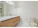 A modern bathroom featuring a floating vanity, large mirror, and sleek fixtures at 14537 Mirabelle Vista Cir, Tampa, FL 33626