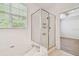 Bathroom featuring a tub and a shower with glass door and windows at 14537 Mirabelle Vista Cir, Tampa, FL 33626
