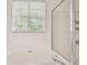Bathroom featuring a tub and a shower with glass door and windows at 14537 Mirabelle Vista Cir, Tampa, FL 33626