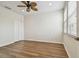 Empty bedroom featuring wood-look floors, windows and ceiling fan at 14537 Mirabelle Vista Cir, Tampa, FL 33626