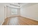 Spacious bedroom featuring tray ceiling, ceiling fan, and wood-look floors at 14537 Mirabelle Vista Cir, Tampa, FL 33626