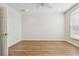 Bedroom featuring wood-look flooring and a window, providing a bright and airy space at 14537 Mirabelle Vista Cir, Tampa, FL 33626