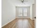 Bright bedroom featuring two windows and wood-look flooring, perfect for relaxation at 14537 Mirabelle Vista Cir, Tampa, FL 33626