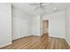 Bedroom featuring wood-look flooring, ceiling fan, closet, and plenty of natural light at 14537 Mirabelle Vista Cir, Tampa, FL 33626