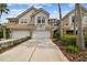 Attractive home exterior boasts a neutral color scheme, well-kept landscaping, and attached two-car garages at 14537 Mirabelle Vista Cir, Tampa, FL 33626