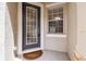 Inviting front door with sidelight window providing natural light, set in neutral stucco wall at 14537 Mirabelle Vista Cir, Tampa, FL 33626