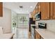 Well-lit kitchen with modern appliances, tile floors, and sliding glass doors leading to outdoor space at 14537 Mirabelle Vista Cir, Tampa, FL 33626