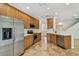 Bright kitchen features stainless steel appliances, wood cabinets, and tile floors at 14537 Mirabelle Vista Cir, Tampa, FL 33626