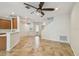 An open living room with tile floors, ceiling fan, and stairs to the second floor at 14537 Mirabelle Vista Cir, Tampa, FL 33626