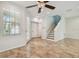 Sunlit living area with tile flooring, ceiling fan, and multiple access points to other areas of the home at 14537 Mirabelle Vista Cir, Tampa, FL 33626