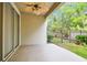 Covered patio with a ceiling fan, offering a relaxing outdoor space with a view of the fenced yard at 14537 Mirabelle Vista Cir, Tampa, FL 33626