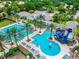 Resort style pool with palm trees, lounge chairs, a blue waterslide, and seating areas at 14537 Mirabelle Vista Cir, Tampa, FL 33626