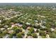 An aerial view showcasing a community surrounded by verdant trees and well-maintained landscapes at 1486 Mahogany Ln # 703, Palm Harbor, FL 34683