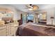 Bedroom featuring an oversized bed, mirrored wall, ceiling fan, and French doors at 1486 Mahogany Ln # 703, Palm Harbor, FL 34683