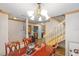 Formal dining room featuring a wood table, chandelier and staircase at 1486 Mahogany Ln # 703, Palm Harbor, FL 34683