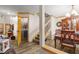 Bright foyer with hardwood floors, wood trim, staircase and view of the formal dining room at 1486 Mahogany Ln # 703, Palm Harbor, FL 34683