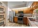 Kitchen featuring stainless appliances, light wood cabinets, and view of backyard through window at 1486 Mahogany Ln # 703, Palm Harbor, FL 34683
