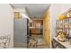Eat-in kitchen featuring stainless appliances, light wood cabinets, tile counters, and casual dining area at 1486 Mahogany Ln # 703, Palm Harbor, FL 34683