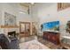 Bright living room boasting high ceilings, fireplace, and double French doors leading to outdoor space at 1486 Mahogany Ln # 703, Palm Harbor, FL 34683