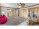 Inviting main bedroom boasting a ceiling fan, four-poster bed, and views to screened porch at 1486 Mahogany Ln # 703, Palm Harbor, FL 34683