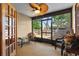 Relaxing screened porch with ceiling fan, wicker furniture, and serene backyard views at 1486 Mahogany Ln # 703, Palm Harbor, FL 34683