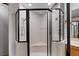 Bathroom featuring an enclosed tiled shower with glass doors and a corner seat at 1486 Mahogany Ln # 703, Palm Harbor, FL 34683