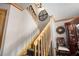 Bright staircase with natural wood railings, modern light fixture, and decorative wall decor at 1486 Mahogany Ln # 703, Palm Harbor, FL 34683