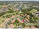 An aerial view of community including mature trees, golf course, tennis courts, water features, and residential housing at 15 Tads Trl, Oldsmar, FL 34677