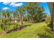 Expansive backyard with lush landscaping and mature trees, perfect for outdoor activities at 15 Tads Trl, Oldsmar, FL 34677