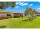 Well-maintained backyard features a screened patio and beautiful landscaping at 15 Tads Trl, Oldsmar, FL 34677