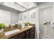 Bathroom featuring double sinks with granite countertops and dark wood cabinets at 15 Tads Trl, Oldsmar, FL 34677