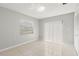 Bright bedroom with neutral walls, tile flooring, and natural light through the sliding glass door at 15 Tads Trl, Oldsmar, FL 34677