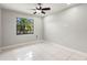 Bedroom featuring a ceiling fan, tile flooring, neutral paint, and a window at 15 Tads Trl, Oldsmar, FL 34677