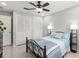 Bedroom featuring a ceiling fan, tile flooring, neutral paint, and closet with bifold doors at 15 Tads Trl, Oldsmar, FL 34677