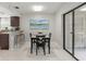 Cozy dining area with modern table set, artwork, and access to the outdoor patio at 15 Tads Trl, Oldsmar, FL 34677