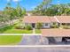 Charming single-story home with manicured lawn, carport, and lush landscaping at 15 Tads Trl, Oldsmar, FL 34677