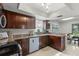 Renovated kitchen with granite countertops, stainless steel appliances, and cherry wood cabinets at 15 Tads Trl, Oldsmar, FL 34677