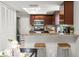 Well-lit kitchen features stainless appliances, granite countertops, and counter seating at 15 Tads Trl, Oldsmar, FL 34677