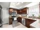 Updated kitchen features stainless appliances, granite countertops, and cherry cabinets at 15 Tads Trl, Oldsmar, FL 34677