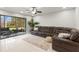 Spacious living room with a large leather sectional, tile floors and sliding doors to the lanai at 15 Tads Trl, Oldsmar, FL 34677